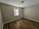 Clean bedroom featuring a large window and hardwood floors at 432 Independence Dr, Jonesboro, GA 30238