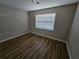 Clean bedroom featuring a large window and hardwood floors at 432 Independence Dr, Jonesboro, GA 30238