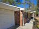 Charming brick home featuring a convenient one-car garage and inviting covered entrance at 432 Independence Dr, Jonesboro, GA 30238