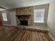 Cozy living room boasts a stone fireplace, hardwood floors, and plenty of natural light at 432 Independence Dr, Jonesboro, GA 30238