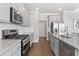 Modern kitchen with gray cabinets, granite countertops and stainless steel appliances at 480 Paces Dr, Lithia Springs, GA 30122