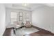 Bedroom sitting area with 2 chairs, neutral carpet, and 2 windows that let in natural light at 3261 Ferncliff Ln, Atlanta, GA 30324