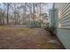 Home's backyard with wooded area and steps leading up to a deck at 6305 Holborne Ln, Douglasville, GA 30134