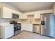 Modern kitchen with white cabinets and stainless steel appliances at 6305 Holborne Ln, Douglasville, GA 30134