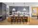 Gourmet kitchen features gray cabinetry, quartz countertops, and breakfast bar at 6430 Pond View Dr, Cumming, GA 30028