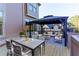 The back deck with an outdoor dining table and seating under a modern gazebo at 123 Fernwood Dr, Woodstock, GA 30188