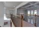 Hallway with detailed coffered ceilings, wrought iron railing, and natural light at 123 Fernwood Dr, Woodstock, GA 30188