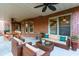 Covered patio featuring comfortable outdoor seating, a ceiling fan, and brick surround at 123 Fernwood Dr, Woodstock, GA 30188