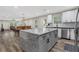 Modern kitchen with gray island, white cabinets, and stainless steel appliances at 235 Holly Nw Rd, Atlanta, GA 30314