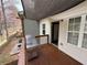 View of a cozy back porch with a grill, sunshade, access to the home's entrance, and a view of the backyard at 2912 Ashlyn Pointe Dr, Atlanta, GA 30340