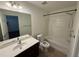 Well-lit bathroom featuring a combination tub and shower unit and vanity with a dark wood cabinet at 2912 Ashlyn Pointe Dr, Atlanta, GA 30340