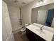 Bathroom with a tub-shower, toilet, and dark vanity with a large mirror at 2912 Ashlyn Pointe Dr, Atlanta, GA 30340