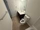 Bathroom showcasing a vanity with a dark wood cabinet, a toilet, and neutral-toned flooring at 2912 Ashlyn Pointe Dr, Atlanta, GA 30340