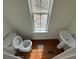 Small bathroom featuring wood floors, a pedestal sink, toilet, and a window providing natural light at 2912 Ashlyn Pointe Dr, Atlanta, GA 30340
