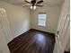 Cozy bedroom featuring wood-look floors, a window, and a ceiling fan at 2912 Ashlyn Pointe Dr, Atlanta, GA 30340