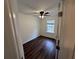 Bedroom showcasing wood-look flooring, a window, and a ceiling fan at 2912 Ashlyn Pointe Dr, Atlanta, GA 30340