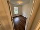 Modest bedroom with dark wood-look floors and a window at 2912 Ashlyn Pointe Dr, Atlanta, GA 30340