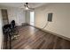 Room features wood-look flooring, a painted brick accent wall and a ceiling fan at 2912 Ashlyn Pointe Dr, Atlanta, GA 30340