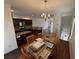 Open-concept design showcasing the dining room, kitchen with dark wood cabinets and granite counters, and staircase at 2912 Ashlyn Pointe Dr, Atlanta, GA 30340