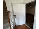 View of the front door opening into a room with wood-look flooring and access to stairs at 2912 Ashlyn Pointe Dr, Atlanta, GA 30340