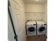 Convenient laundry room with washer, dryer, and shelving for storage at 2912 Ashlyn Pointe Dr, Atlanta, GA 30340