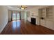 Spacious living room featuring hardwood floors, fireplace, and built-in shelving at 2912 Ashlyn Pointe Dr, Atlanta, GA 30340
