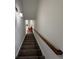 Carpeted staircase with wooden handrail leading to the upper level of the home at 2912 Ashlyn Pointe Dr, Atlanta, GA 30340