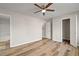 Bright bedroom with ceiling fan, hardwood floors, and walk-in closet at 319 Quincy Ave, Mcdonough, GA 30253
