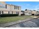 Townhouse community featuring multiple tan-sided units at 319 Quincy Ave, Mcdonough, GA 30253