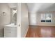 Small half bathroom with white vanity and mirror at 319 Quincy Ave, Mcdonough, GA 30253