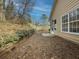 Simple backyard with gravel ground cover and wooden retaining wall at 752 Bostonian Way, Lawrenceville, GA 30046