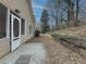 Landscaped backyard with gravel patio and wooden retaining wall at 752 Bostonian Way, Lawrenceville, GA 30046