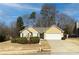 Ranch style home with attached garage, manicured lawn, and mature trees at 752 Bostonian Way, Lawrenceville, GA 30046