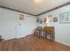 Home office with hardwood floors, double door closet, and a built-in desk at 752 Bostonian Way, Lawrenceville, GA 30046