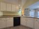 Stylish kitchen with white cabinets, black appliances, and a corner sink at 752 Bostonian Way, Lawrenceville, GA 30046