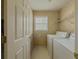 Laundry room with washer, dryer, and shelving at 752 Bostonian Way, Lawrenceville, GA 30046