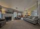 Living room with neutral carpeting, fireplace, and ample natural light at 752 Bostonian Way, Lawrenceville, GA 30046