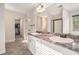 Double vanity bathroom with granite countertop and walk-in shower at 1005 Greenridge Trl, Loganville, GA 30052