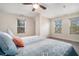 Bright bedroom with ceiling fan and large windows at 1005 Greenridge Trl, Loganville, GA 30052