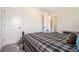 Cozy bedroom with carpeted floor and plaid bedding at 1005 Greenridge Trl, Loganville, GA 30052