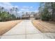 Long driveway leading to a two-story house at 1005 Greenridge Trl, Loganville, GA 30052