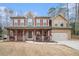 Two-story house with stone accents, red shutters, and a porch at 1005 Greenridge Trl, Loganville, GA 30052