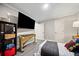 Spacious bedroom with a large TV and musical instrument at 2958 Arden Ridge Ter, Suwanee, GA 30024