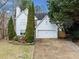 Two-story white house with driveway, landscaping, and double garage at 2958 Arden Ridge Ter, Suwanee, GA 30024