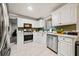 White kitchen cabinets, stainless steel appliances, and tile floors at 2958 Arden Ridge Ter, Suwanee, GA 30024