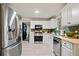 Bright kitchen featuring white cabinets and stainless steel appliances at 2958 Arden Ridge Ter, Suwanee, GA 30024