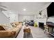 Living room with fireplace, tan couch, and wood floors at 2958 Arden Ridge Ter, Suwanee, GA 30024