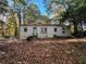 Rear view of a white brick house with access to backyard at 1814 N Druid Hills Ne Rd, Brookhaven, GA 30319