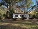Charming ranch house with a white brick exterior, nestled amongst trees at 1814 N Druid Hills Ne Rd, Brookhaven, GA 30319