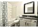 Clean bathroom, featuring a tub shower, vanity, and dark framed mirror at 2555 Flat Shoals Rd # 3005, South Fulton, GA 30349